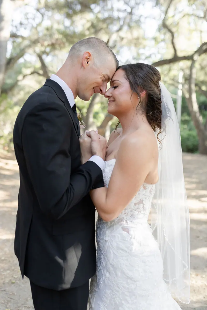 A bride and groom in the oaks after the ceremony.